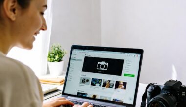 Student exploring photography lessons online on a laptop with a camera nearby
